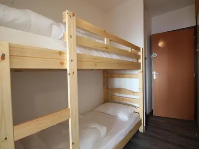 a couple of bunk beds in a room at Studio rénové 4 pers avec balcon sud, proche pistes et commerces, casier à skis, parking - FR-1-687-33 in Arâches-la-Frasse