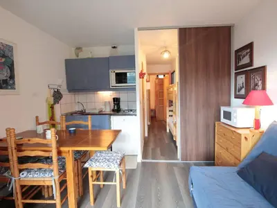 a kitchen and living room with a table and a dining room at Studio lumineux avec balcon et vue sur pistes, animaux admis - FR-1-687-61 in Arâches-la-Frasse
