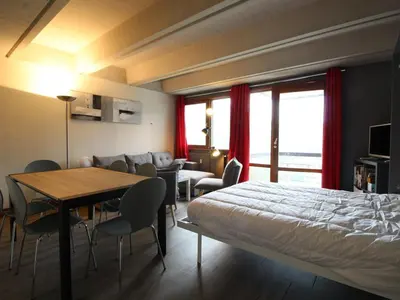 a hotel room with a bed and a table and chairs at 3 Pièces Rénové pour 6 Pers. à Flaine Forum - 50m², Proche Pistes et Commerces - FR-1-687-35 in Arâches-la-Frasse