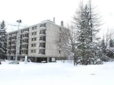 a large building in the snow with a tree at 3 Pièces Rénové pour 6 Pers. à Flaine Forum - 50m², Proche Pistes et Commerces - FR-1-687-35 in Arâches-la-Frasse