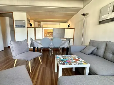 a living room with a couch and a table and chairs at 3 Pièces Rénové pour 6 Pers. à Flaine Forum - 50m², Proche Pistes et Commerces - FR-1-687-35 in Arâches-la-Frasse