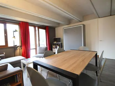 a living room with a wooden table and chairs at 3 Pièces Rénové pour 6 Pers. à Flaine Forum - 50m², Proche Pistes et Commerces - FR-1-687-35 in Arâches-la-Frasse