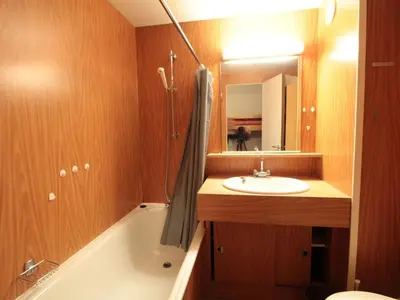 a bathroom with a sink and a tub and a mirror at Studio Coin Montagne 25m² à Flaine, balcon et proximité pistes - FR-1-687-42 in Arâches-la-Frasse