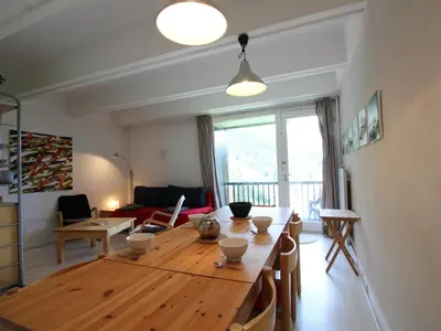 a living room with a wooden table and a dining room at Appartement 2 Pièces pour 6 Personnes au Pied des Pistes – Flaine Forum, Résidence Aldebarran - FR-1-687-99 in Arâches-la-Frasse
