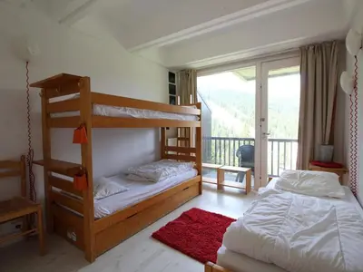 a bedroom with two bunk beds and a balcony at Appartement 2 Pièces pour 6 Personnes au Pied des Pistes – Flaine Forum, Résidence Aldebarran - FR-1-687-99 in Arâches-la-Frasse