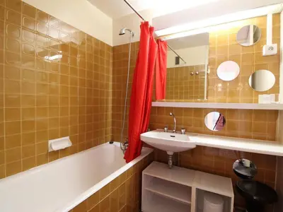 a bathroom with a tub and a sink and a mirror at Appartement 2 Pièces pour 6 Personnes au Pied des Pistes – Flaine Forum, Résidence Aldebarran - FR-1-687-99 in Arâches-la-Frasse