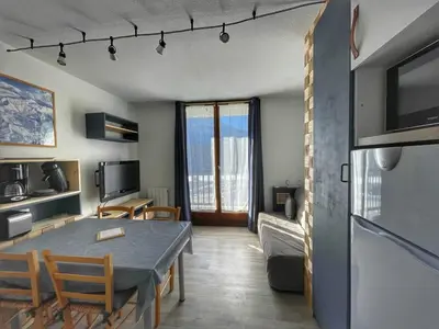 a kitchen and living room with a table and chairs at Charmant Studio Cabine avec Coin Montagne pour 5 Pers., Résidence Doris, Proche Pistes et Commerces. - FR-1-687-62 in Arâches-la-Frasse