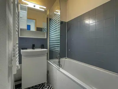 a bathroom with a tub and a sink and a mirror at Charmant Studio Cabine avec Coin Montagne pour 5 Pers., Résidence Doris, Proche Pistes et Commerces. - FR-1-687-62 in Arâches-la-Frasse