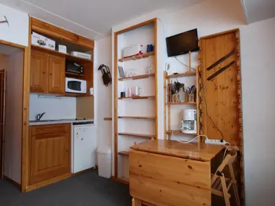 a kitchen with wooden cabinets and a counter top at Studio cosy 4 pers, skis aux pieds, terrasse sud, Flaine Front de Neige - FR-1-687-73 in Arâches-la-Frasse