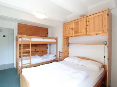 a bedroom with two bunk beds with white sheets at Appartement 2 pièces pour 6 personnes, au pied des pistes – Résidence Aldebaran, Flaine Forum - FR-1-687-95 in Arâches-la-Frasse