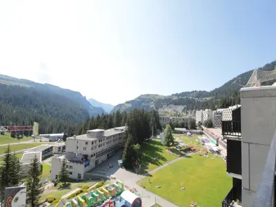 a view of a building with a park and mountains at Appartement 2 pièces pour 6 personnes, au pied des pistes – Résidence Aldebaran, Flaine Forum - FR-1-687-95 in Arâches-la-Frasse