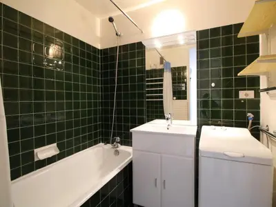 a green tiled bathroom with a tub and a sink at Appartement 2 pièces pour 6 personnes, au pied des pistes – Résidence Aldebaran, Flaine Forum - FR-1-687-95 in Arâches-la-Frasse