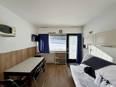 a room with a desk and a bed and a table at Studio 4 pers. sur les pistes à Flaine, parking, casier à skis, terrasse - FR-1-687-75 in Arâches-la-Frasse