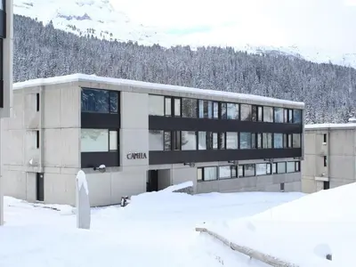 a building in the snow in front of a mountain at Studio 4 pers. sur les pistes à Flaine, parking, casier à skis, terrasse - FR-1-687-75 in Arâches-la-Frasse