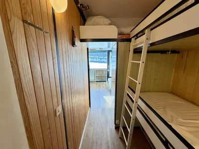 a small room with two bunk beds and a hallway at Studio 4 pers. sur les pistes à Flaine, parking, casier à skis, terrasse - FR-1-687-75 in Arâches-la-Frasse