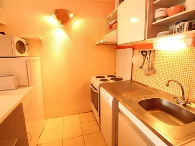 a small kitchen with a sink and a stove at Appartement spacieux 8 pers, balcon sud, Flaine Forum - FR-1-687-80 in Arâches-la-Frasse