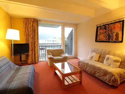 a living room with a couch and a table at Appartement spacieux 8 pers, balcon sud, Flaine Forum - FR-1-687-80 in Arâches-la-Frasse