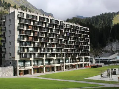 a large building with a grass field in front of it at Appartement spacieux 8 pers, balcon sud, Flaine Forum - FR-1-687-80 in Arâches-la-Frasse