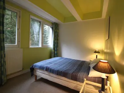 a bedroom with a bed and two windows at Appartement spacieux 8 pers, balcon sud, Flaine Forum - FR-1-687-80 in Arâches-la-Frasse