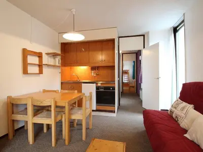 a living room with a table and a kitchen at Appartement 2 Pièces 6 Personnes, Balcon, proche Pistes et Commerces, Flaine Forêt - FR-1-687-77 in Arâches-la-Frasse