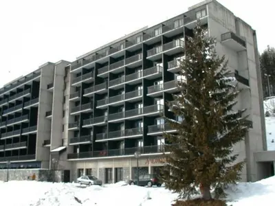 a large building with a christmas tree in front of it at Appartement 2 Pièces 6 Personnes, Balcon, proche Pistes et Commerces, Flaine Forêt - FR-1-687-77 in Arâches-la-Frasse