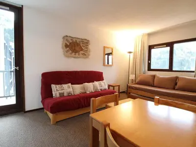 a living room with a red couch and a table at Appartement 2 Pièces 6 Personnes, Balcon, proche Pistes et Commerces, Flaine Forêt - FR-1-687-77 in Arâches-la-Frasse