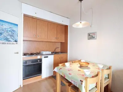a kitchen with a table and a kitchen with a stove at Studio cosy pour 4 personnes - résidence Andromède, Flaine Forêt, proche pistes et commerces - FR-1-687-107 in Arâches-la-Frasse