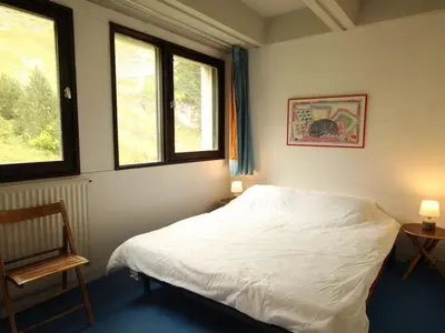 a bedroom with a white bed and two windows at Appartement 3 pièces pour 8 pers. au pied des pistes – Résidence Aldebarran, Flaine Forum - FR-1-687-98 in Arâches-la-Frasse