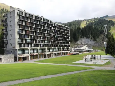 a large building with a green field in front of it at Appartement 3 pièces pour 8 pers. au pied des pistes – Résidence Aldebarran, Flaine Forum - FR-1-687-98 in Arâches-la-Frasse
