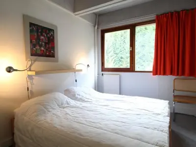 a bedroom with a white bed and a red window at 2 pièces à Flaine, 6 couchages, à 50m des pistes - FR-1-687-89 in Arâches-la-Frasse