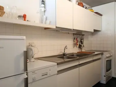 a kitchen with white cabinets and a sink at 2 pièces à Flaine, 6 couchages, à 50m des pistes - FR-1-687-89 in Arâches-la-Frasse