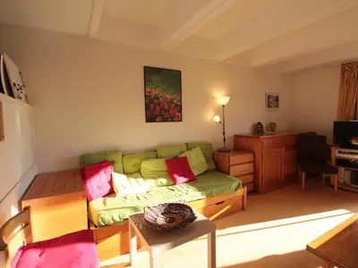 a living room with a green couch and a table at Flaine, 3 pièces, 8 pers, près des pistes, vue domaine skiable - FR-1-687-83 in Arâches-la-Frasse