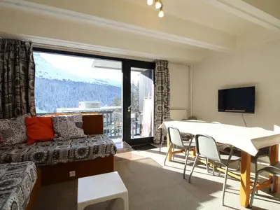 a living room with a couch and a table with chairs at Charmant Appartement 2P, 6 Couchages, Pied des Pistes - Résidence Aldebaran, Flaine Forum - FR-1-687-101 in Arâches-la-Frasse