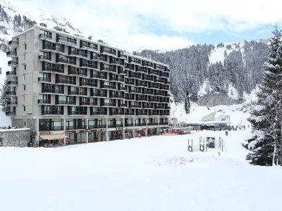 a large building in the snow in front of a mountain at Charmant Appartement 2P, 6 Couchages, Pied des Pistes - Résidence Aldebaran, Flaine Forum - FR-1-687-101 in Arâches-la-Frasse