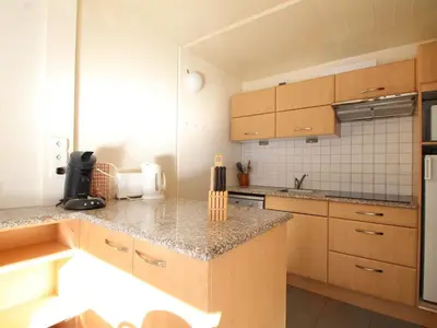 a kitchen with wooden cabinets and granite counter tops at Charmant Appartement 2P, 6 Couchages, Pied des Pistes - Résidence Aldebaran, Flaine Forum - FR-1-687-101 in Arâches-la-Frasse