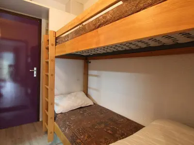 a room with two bunk beds and a door at Studio pour 4 personnes proche pistes et commerces à Flaine Forêt - FR-1-687-105 in Arâches-la-Frasse