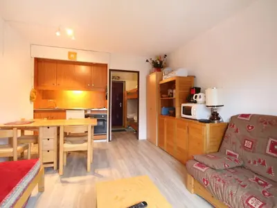 a kitchen and living room with a table and a couch at Studio pour 4 personnes proche pistes et commerces à Flaine Forêt - FR-1-687-105 in Arâches-la-Frasse