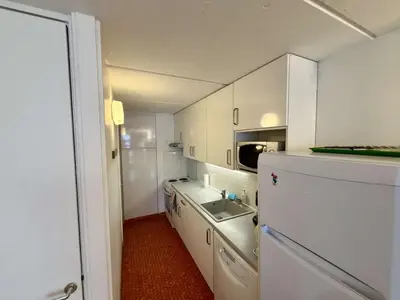 a kitchen with a white refrigerator and a sink at Appartement 3 pièces, 8 pers, Résidence Cassiopée, Flaine Forum, à 50m des pistes et commerces - FR-1-687-87 in Arâches-la-Frasse
