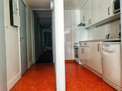 a kitchen with white cabinets and an orange floor at Appartement 3 pièces, 8 pers, Résidence Cassiopée, Flaine Forum, à 50m des pistes et commerces - FR-1-687-87 in Arâches-la-Frasse