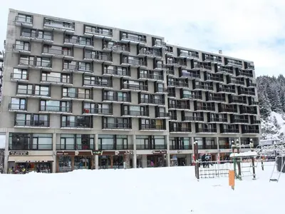 a large building with snow in front of it at Studio rénové pour 4 pers, balcon, au pied des pistes et commerces - FR-1-687-111 in Arâches-la-Frasse