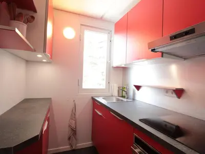 a small kitchen with red cabinets and a window at Studio rénové pour 4 pers, balcon, au pied des pistes et commerces - FR-1-687-111 in Arâches-la-Frasse
