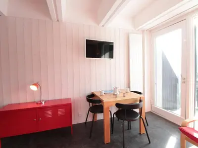 a room with a table and chairs and a red cabinet at Studio rénové pour 4 pers, balcon, au pied des pistes et commerces - FR-1-687-111 in Arâches-la-Frasse