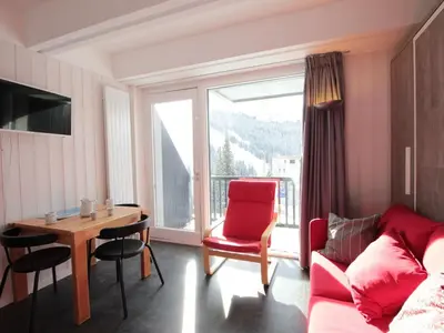 a living room with a couch and a table and a window at Studio rénové pour 4 pers, balcon, au pied des pistes et commerces - FR-1-687-111 in Arâches-la-Frasse