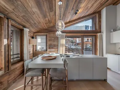 a kitchen with a table and chairs in a room at Chalet Familial Megève avec Espace Wellness - FR-1-569-56 in Megève
