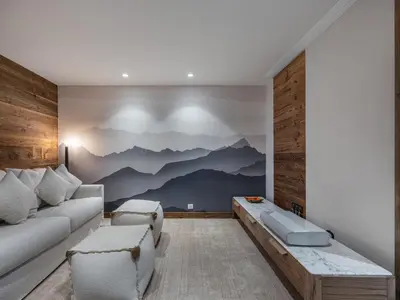 a living room with a mountain mural on the wall at Chalet Familial Megève avec Espace Wellness - FR-1-569-56 in Megève
