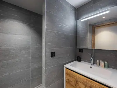 a bathroom with a sink and a mirror at Chalet Familial Megève avec Espace Wellness - FR-1-569-56 in Megève