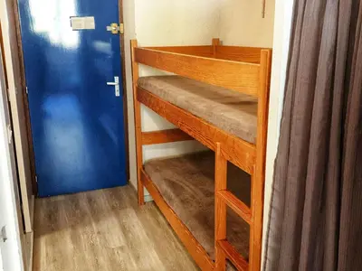 a room with a bunk bed with a blue door at Studio 5 pers à Flaine, proche pistes et commerces, animaux admis - FR-1-687-91 in Arâches-la-Frasse