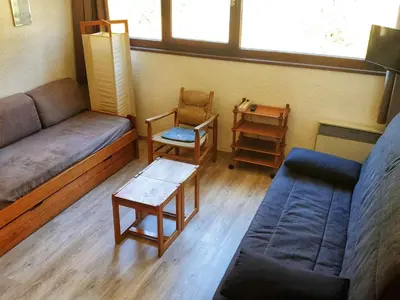 a living room with a couch and a table at Studio 5 pers à Flaine, proche pistes et commerces, animaux admis - FR-1-687-91 in Arâches-la-Frasse