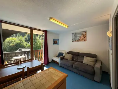 a living room with a couch and a balcony at Studio confortable pour 4 personnes au pied des pistes - FR-1-642-75 in Morillon