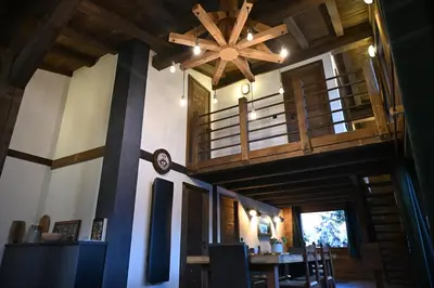 a room with a wooden ceiling and a dining room at Chalet Montana in Combloux